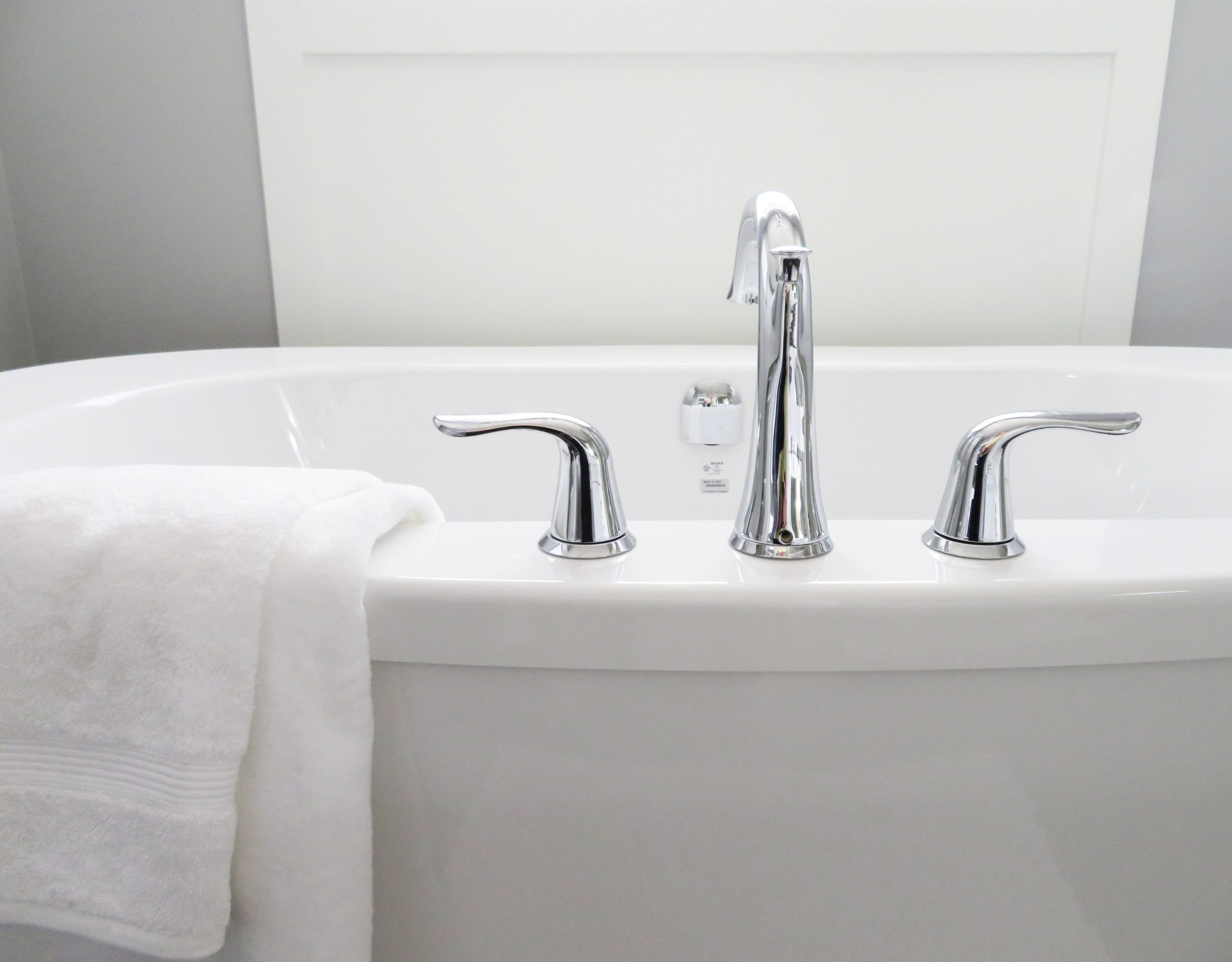 Picture of bath tub fixtures and a white towel